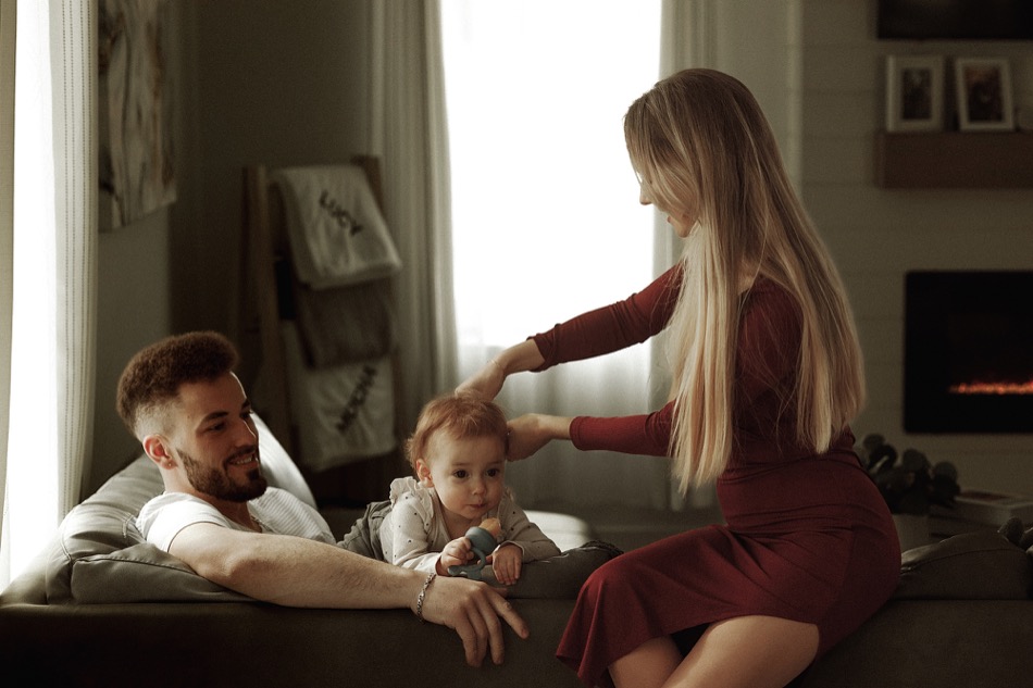 Parents and their baby relaxing together at home