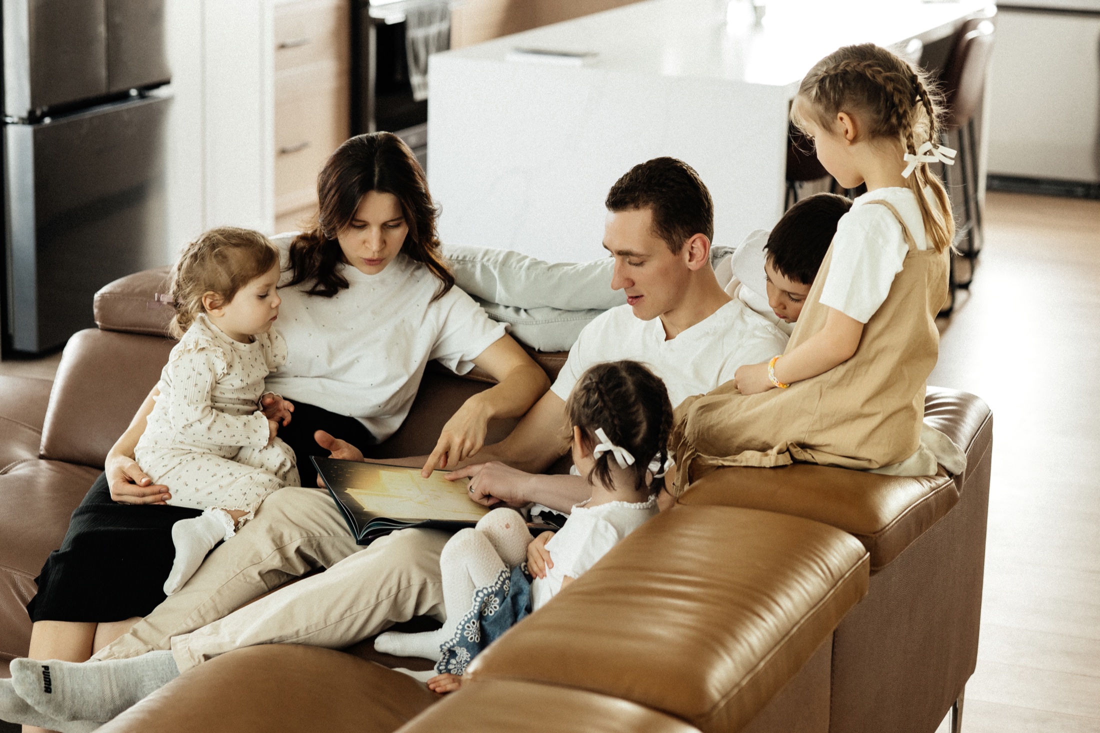 Parents and their little one cuddling together at home