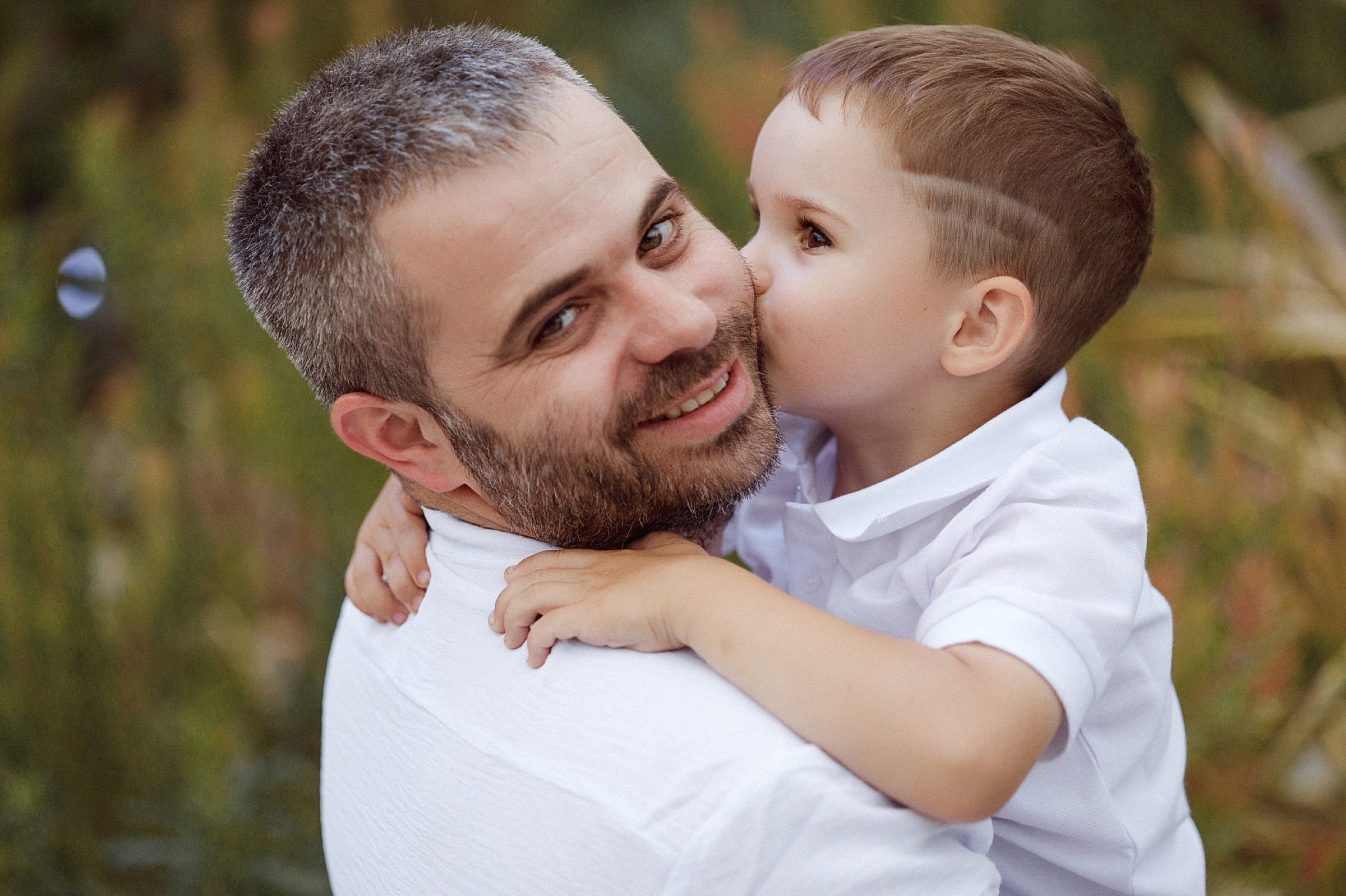 Family sharing a tender moment outside at golden hour