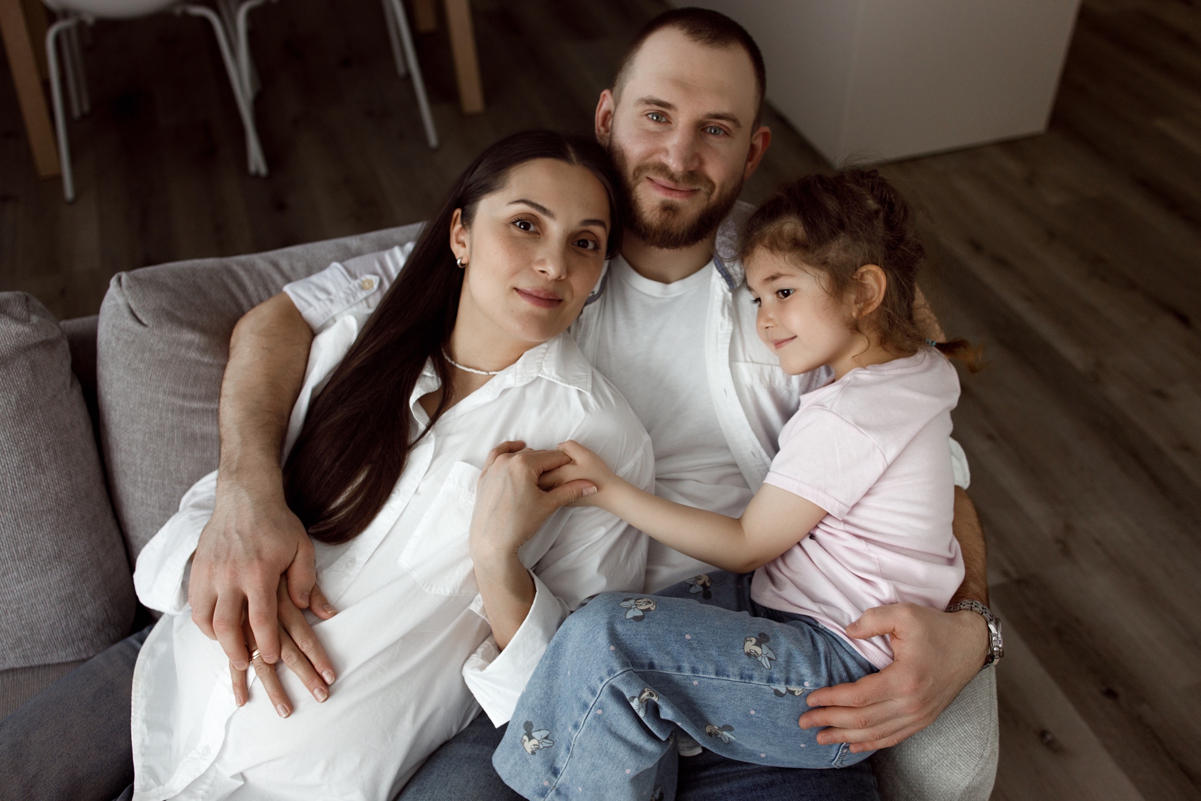 A family sitting close together at home
