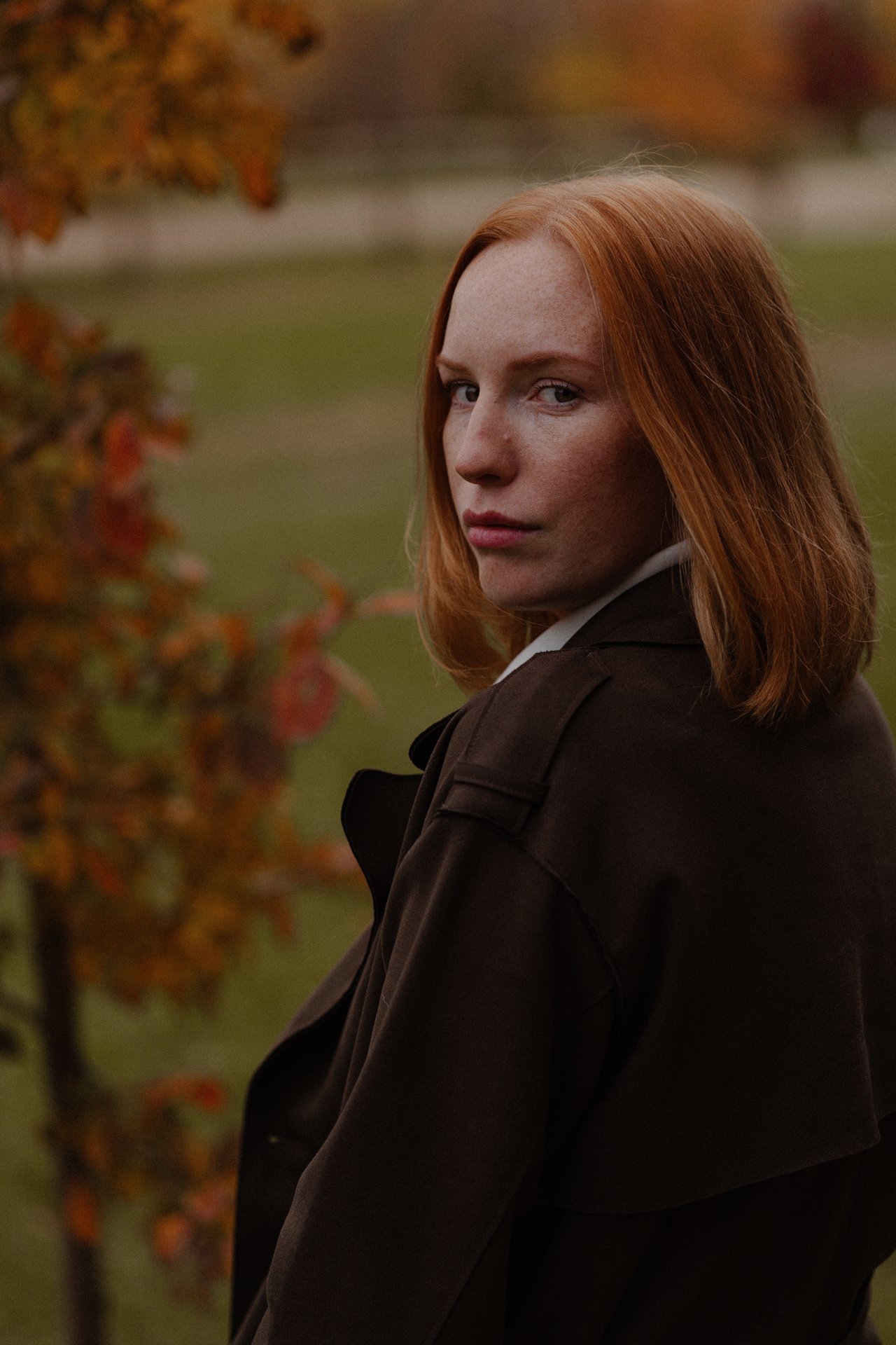 Portrait of Alina outdoors among autumn trees.