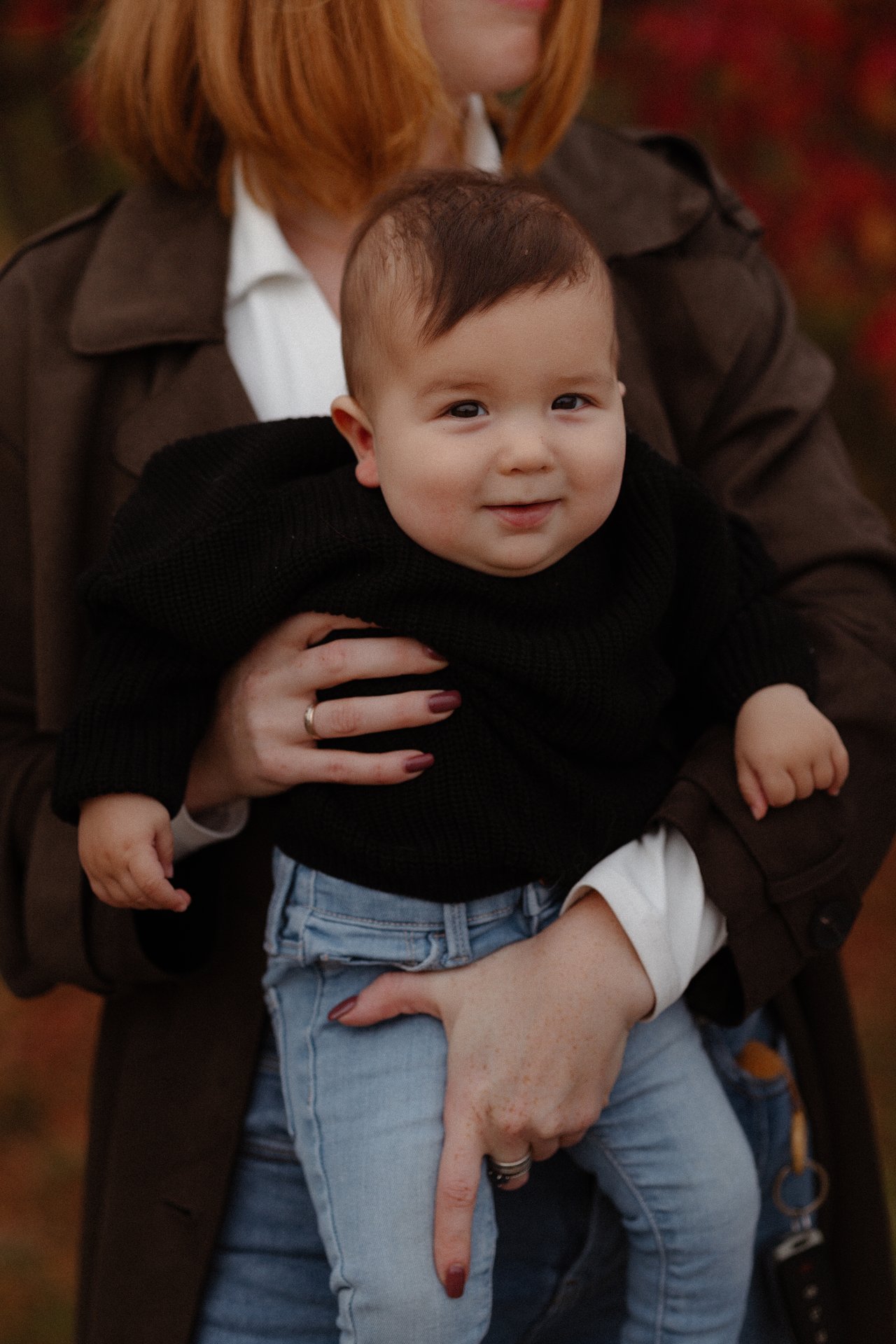 Close portrait of the younger child held by Alina.