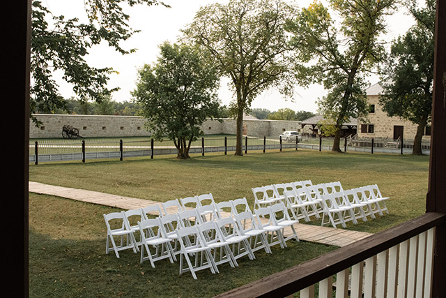 Outdoor wedding ceremony setup on the grounds of Lower Fort Garry
